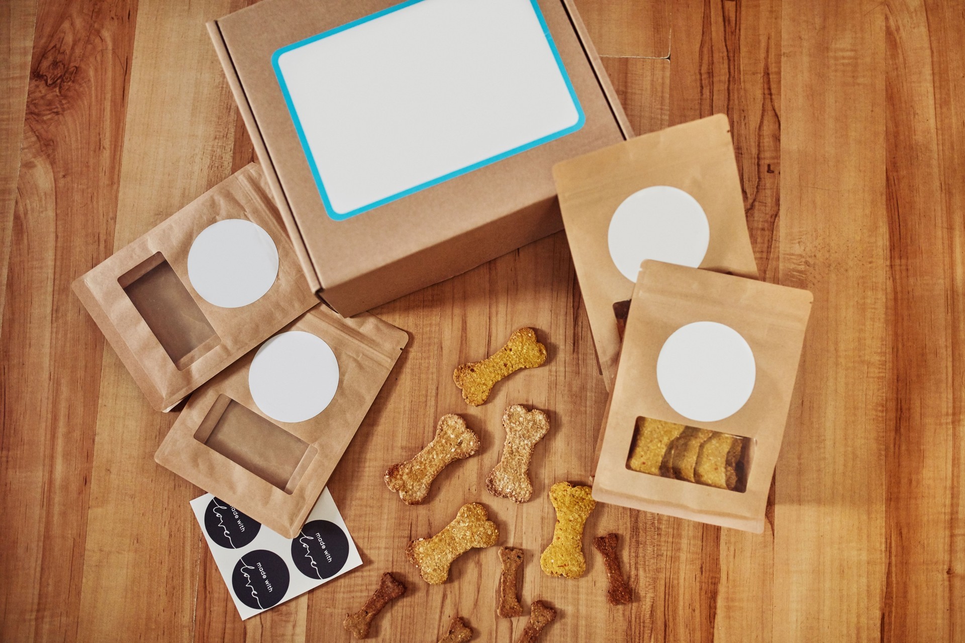 High angle shot of freshly baked dog biscuits and packaged orders on a kitchen counter during the day
